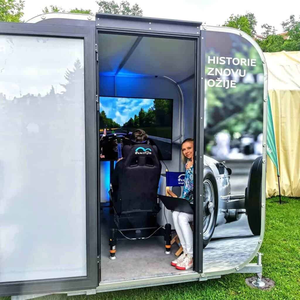 Happy lady in a race car Audi racing simulator rental near London in Great Britain.