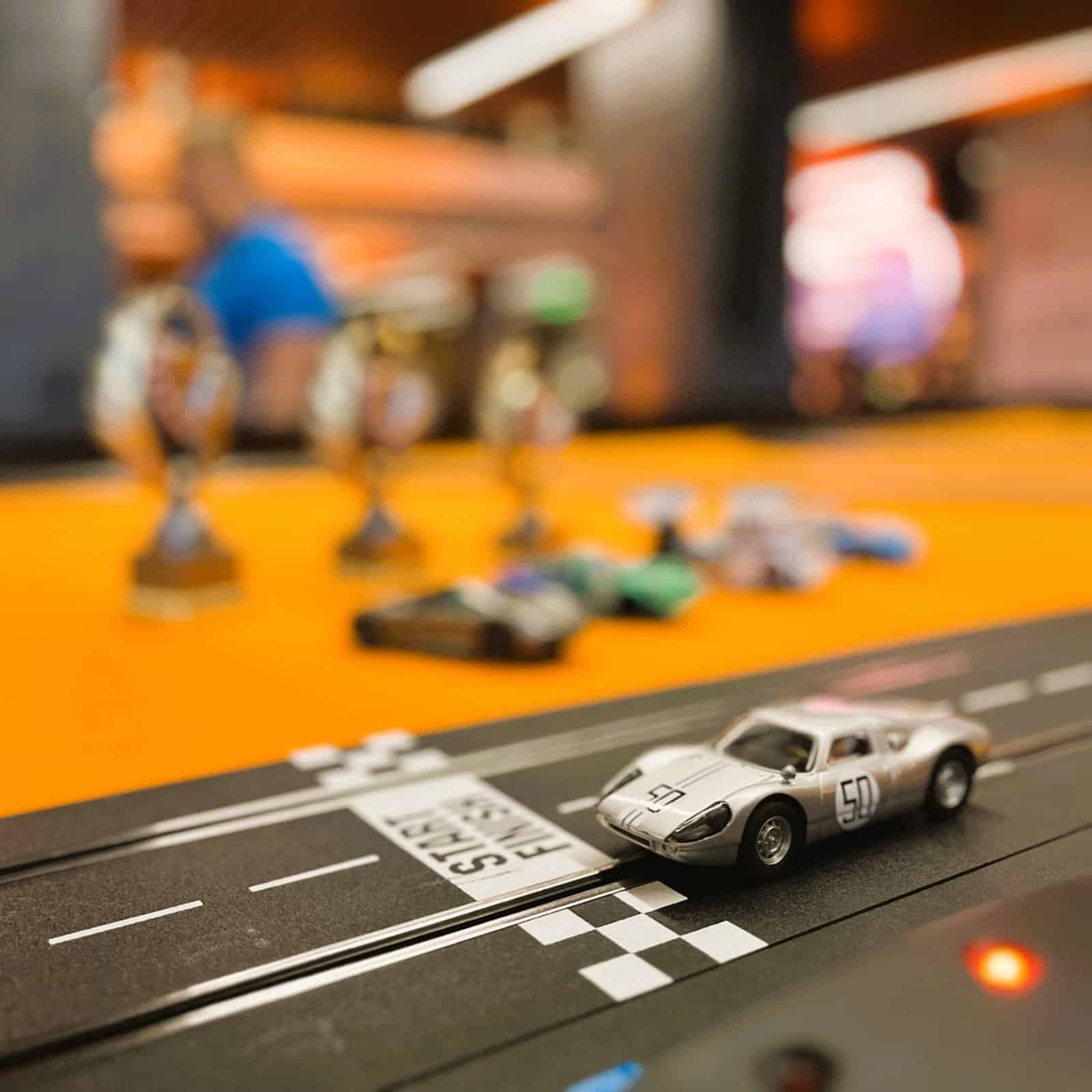 RoarFun Clients Porsche history slot cars race track immersive screen for competition at Porsche sales event