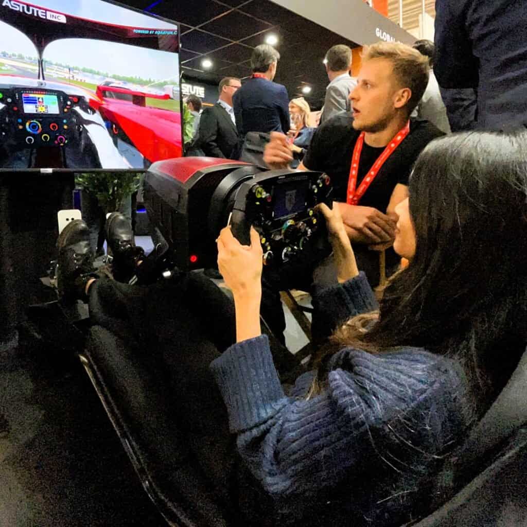 Very happy girl on mobile racing simulator hire.